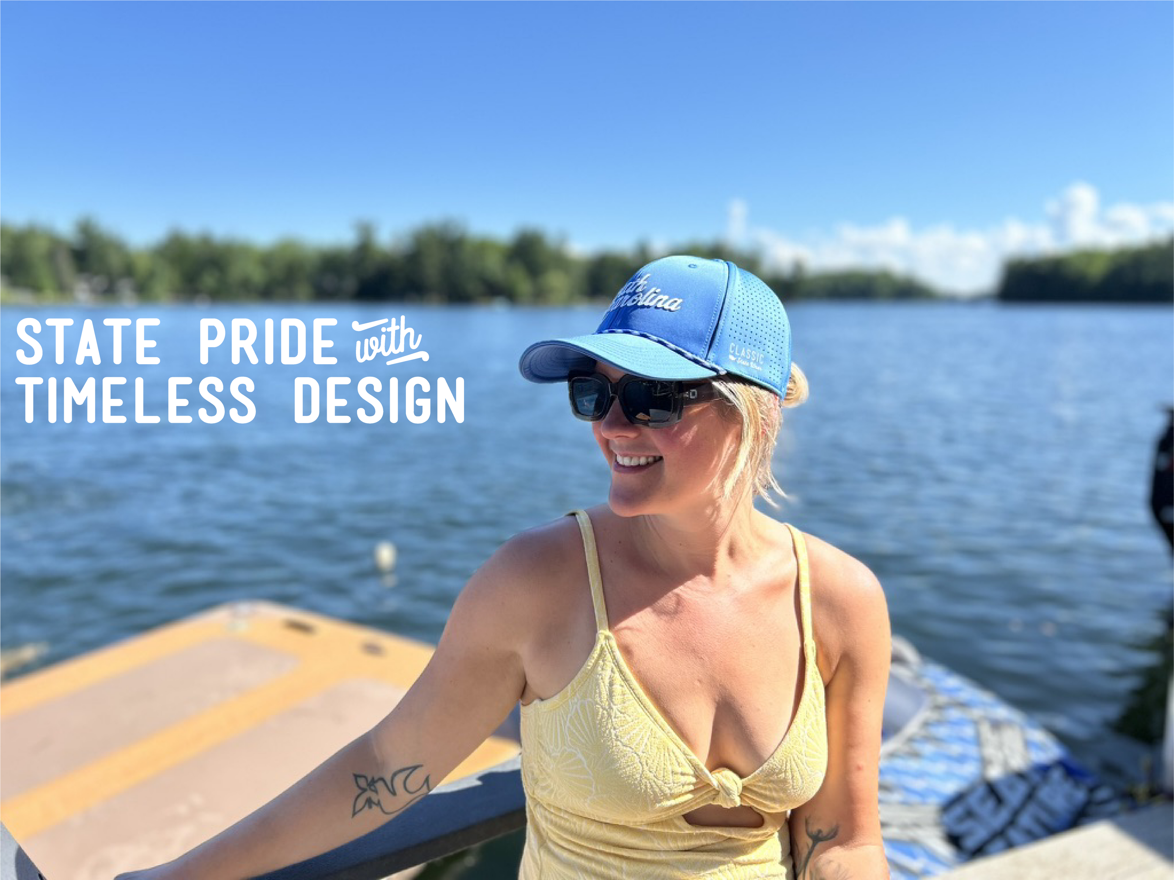 A woman wearing a blue 'South Carolina' Dri fit hat hat, sunglasses, and a yellow top sits on a dock by the water, with the text 'STATE PRIDE with TIMELESS DESIGN' overlaid on the left.